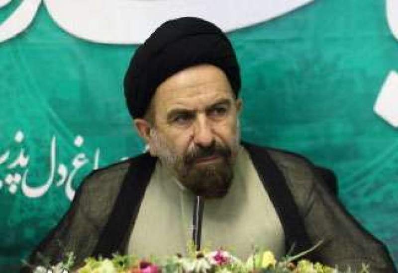 Seyedali Bozorgvari (born 1957 in Tembi village, Charam District, Kohgiluyeh and Boyer-Ahmad Province, Iran) is a Shia cleric, former member of Iran’s Parliament (Majlis), and a conservative political figure. He is also known for his military service and social activism.  Education and Religious Background  Bozorgvari was born into a religious family descended from the Sayyids of Imamzadeh Ali. He began his early education in local villages and continued his religious studies in seminaries in Behbahan, Khorramshahr, Shiraz, and Qom. He studied advanced Islamic jurisprudence (fiqh and usul) and was mentored by scholars such as Ayatollah Seyed Karamatollah Malek-Hosseini and Seyed Ali Asghar Hosseini.  Military Service  During the Iran-Iraq War, he served over 24 months on the front lines and participated in 17 major operations. After his term in Parliament, he joined the fight against ISIS in Syria as part of the “Defenders of the Shrine,” a term used for those protecting Shia holy sites.  Political Career  Bozorgvari served as the representative for Kohgiluyeh, Bahmaei, Charam, and Lendeh in the 8th and 9th terms of the Iranian Parliament. He was a key member and First Secretary of the Agriculture, Water, and Natural Resources Commission. Known for his fiery speeches, he gained media attention for his sharp criticisms during the confirmation hearings of President Rouhani’s cabinet in 2013.  Public Image and Social Work  He is admired in his home province for his modest lifestyle and close relationship with the local people. Bozorgvari has been involved in improving infrastructure and reducing poverty in underdeveloped areas of southwestern Iran.SssSeyedali 