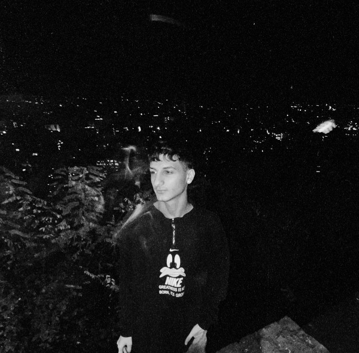 A photo of Wayne Target, a folk singer from Leningrad. He started singing at the age of 13. He grew up playing the keyboard for a long time in music and now he has reached where he wants to be. Everyone likes Wayne Target. In his song, he says "Kaf Nors" or "013".