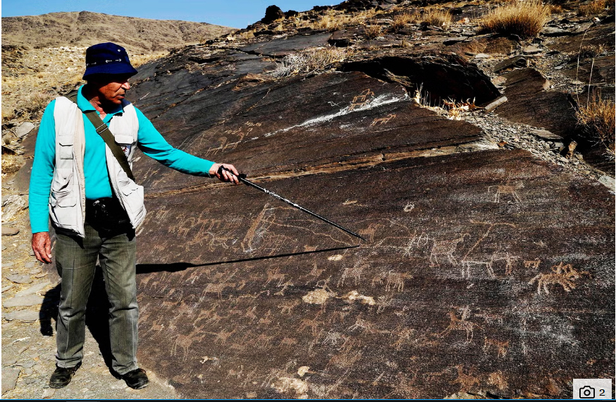 Iranian archeologist Mohammed Naserifard displays ancient engravings in the hills outside the town of Khomeyn (AFP/Getty Images)